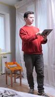 vertical man using tablet during apartment renovation project. renovation project on a tablet video