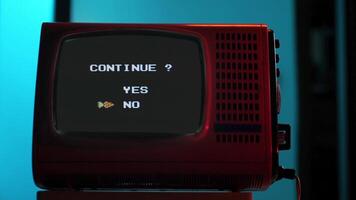 Retro red television displaying continue screen with yes no options. 8 bit console video