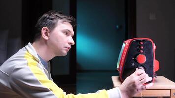 Man changing channels on old vintage TV. Man turning channel knob on old analog TV video