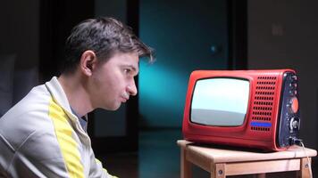 man shakes head negatively, shows head gesture of denial looking at old vintage TV video