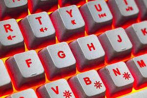 Macro photo of keyboard keys with red yellow bright background rgb color