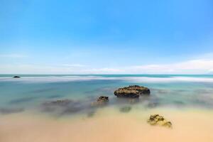 Smooth Ocean Waves Under a Vibrant Sky. Serene Ocean View with Gentle Waves. photo