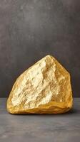Shiny gold nugget on textured surface, symbolizing wealth and investment photo