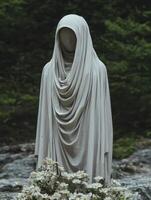 Gray draped fabric figure in front of a stream photo