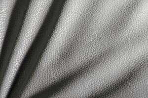 White or gray leather for the background. Creased leather with soft waves. to as texture. photo