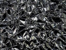 Black silver foil background with crumpled glossy glossy texture for textured background. photo