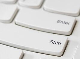Close up of Shift Key on white keyboard of modern laptop photo