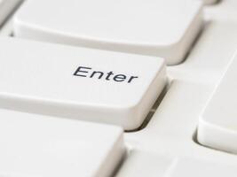 Close up of Enter keys on white keyboard of modern laptop photo