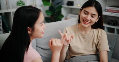 Female couple share good feelings for each other and hold hands with their pinky fingers, indicating a good relationship or sincere promise photo