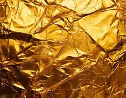 A vibrant, crumpled gold foil background with intricate textures and reflective surfaces, perfect for luxury themed designs, festive, or artistic projects photo