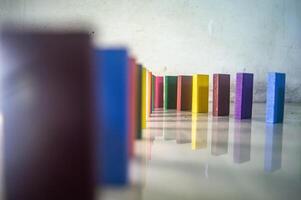 The Colorful wooden blocks in a line on a reflective surface, creating a vibrant pattern photo