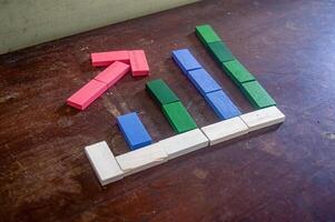 Colorful wooden blocks arranged to form a bar chart on a wooden surface, representing data visualization in a creative and educational way photo