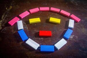 Colorful wooden blocks arranged in a smiley face pattern on a wooden surface, creating a playful and cheerful image photo