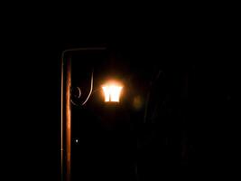 old moody style lamp electric decoration at black night in the dark. photo
