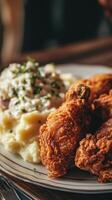 Fried chicken nuggets served with mashed potatoes and onion salad. photo