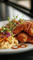 Fried chicken with mashed potatoes and salad on white plate in restaurant photo