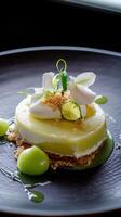 A dessert with lime and cream on a black plate photo