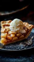 Apple pie with ice cream on a black plate, selective focus. photo