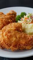 Crispy fried chicken and mashed potatoes and coleslaw salad. photo