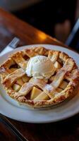 Apple pie with ice cream on wooden background. Selective focus. photo
