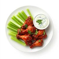 Baked chicken wings with celery and sauce photo