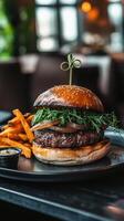 hamburger with french fries on wood table - American food style photo