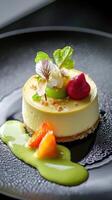 A dessert on a black plate with a green sauce photo