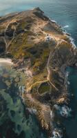 An aerial view of a small island with a lighthouse photo
