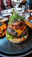 Beef burger with french fries and arugula on white plate photo