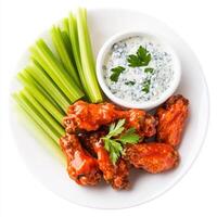 Buffalo chicken wings with celery and blue cheese sauce photo