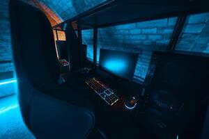 Modern gaming setup with vibrant lighting in a cozy underground room photo