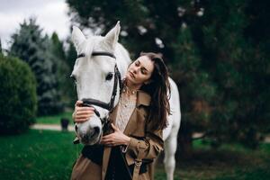 The girl poses with a beautiful horse. photo