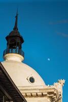 Historical building dome under clear sky with moon visible photo