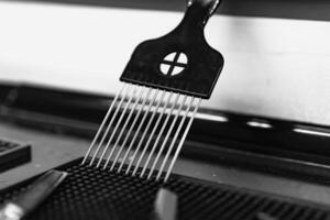 Black comb resting on a barber table in a modern grooming salon photo