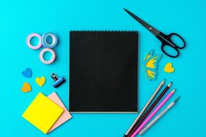 Creative workspace setup with materials for art and organization on a bright blue background photo