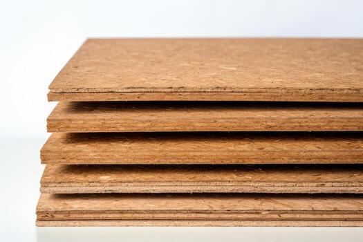 Stack of particle board panels creating a textured surface photo