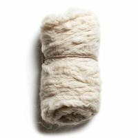 Roll of natural wool yarn tied with string on white background photo