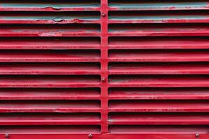 Red metal grille showing signs of rust and wear photo