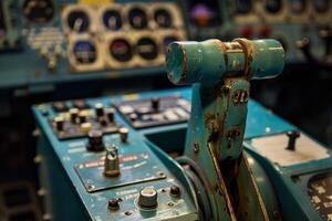 Old airplane control stick standing in cockpit surrounded by buttons and levers photo