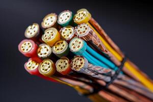 Macro shot of a bundle of colorful electrical wires with exposed copper wires photo