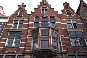 Traditional dutch architecture featuring ornate facade with multiple windows and gables photo