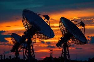 Large array of satellite dishes communicating during sunset photo