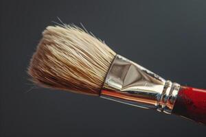 Closeup of a paintbrush showing the bristles on a gray background photo