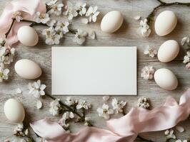 Creative Easter mock up with blank card surrounded by eggs and blossoms for festive design photo
