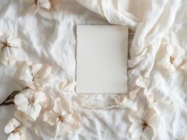 Elegant blank greeting card on floral fabric background for creative design mockup photo