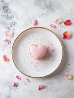 Elegant minimalistic dessert composition featuring a heart shaped pink macaron for romantic occasions photo