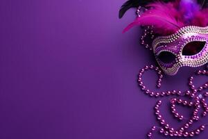 Purple festive carnival mask with feathers and beads on matching background photo