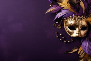 Golden mask with feathers and beads on purple background for mardi gras celebration photo