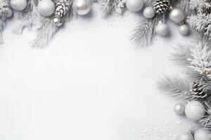 Christmas composition with silver ornaments framing a white background photo