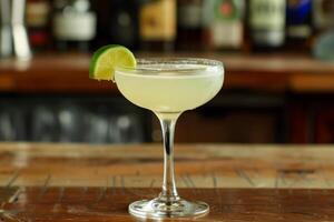 Refreshing gimlet cocktail decorated with lime wheel on bar counter photo